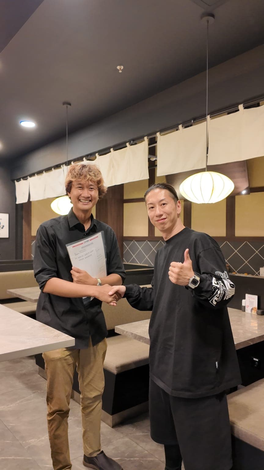 Prasetyo bersalaman dengan klien di sebuah restoran